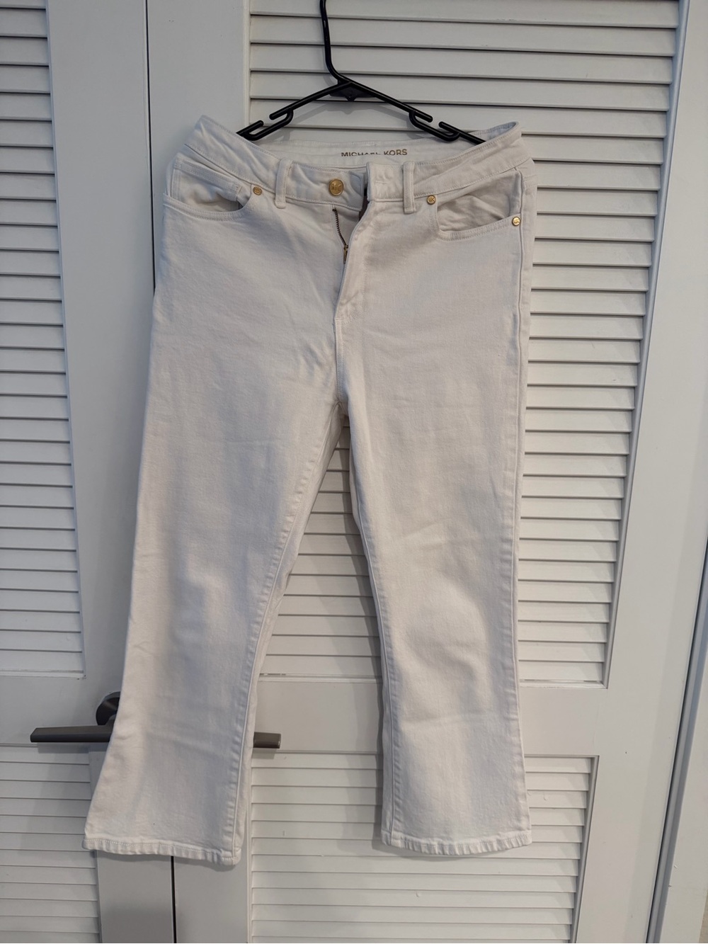 MICHAEL Michael Kors white cropped flare jeans.